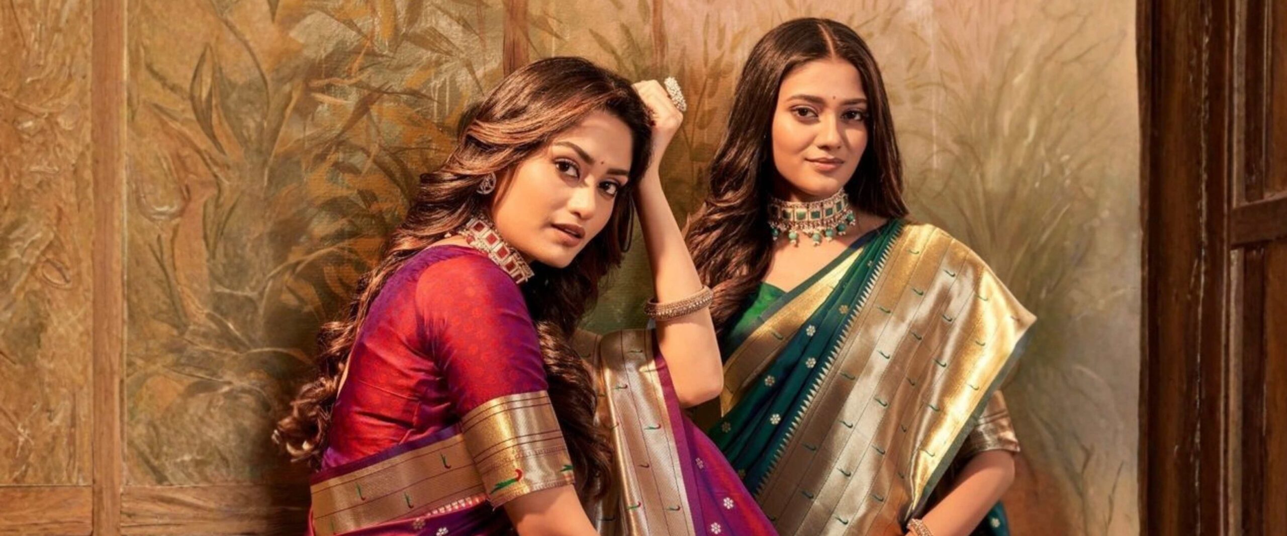 Two Indian women wearing authentic Paithani silk sarees with golden zari border and traditional Maharashtrian jewellery