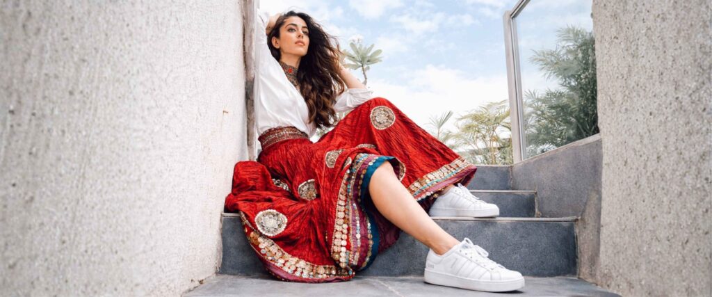 White Dominant Outfit with Contrast Red Skirt wore by a beautiful girl with styled formula of 60-30-10 Brand Maratha is looking extremely beautiful